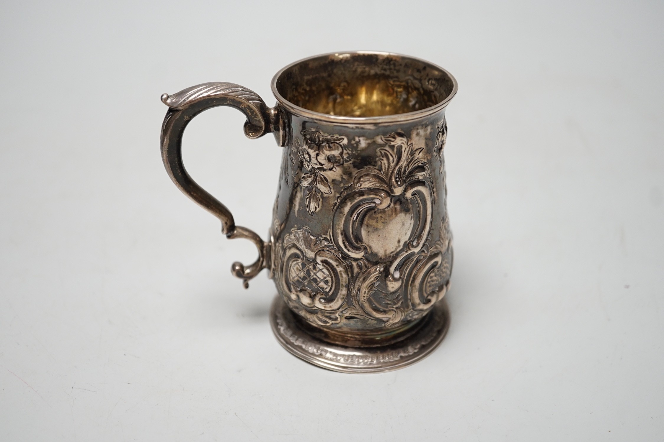 A George III silver small mug, with later embossed decoration, William Cripps, London, 1775, 95mm, 6.1oz.